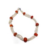 A STRAND OF FRESH WATER CULTURED SEED PEARLS twisted, with coral spacers, 40cm in length, sterling
