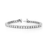 A DIAMOND TENNIS BRACELET claw set with 82 round brilliant cut diamonds weighing approximately 4.