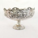 AN ELECTROPLATE ROSE BOWL Wavy rim pierced with bows, the body embossed with peonies, raised on a