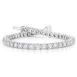 A DIAMOND TENNIS BRACELET claw set with 78 round brilliant cut diamonds weighing approximately 4.