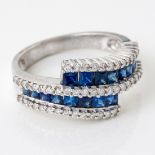 A DIAMOND AND SAPPHIRE CROSSOVER RING