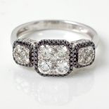 A BLACK AND WHITE DIAMOND CLUSTER RING