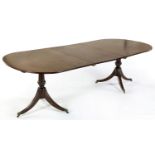 A REGENCY MAHOGANY EXTENDING DINING TABLE