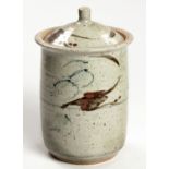 A TALL STONEWARE STORAGE JAR AND COVER