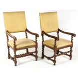 A PAIR OF OAK AND UPHOLSTERED ARMCHAIRS