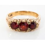 A GARNET THREE-STONE RING