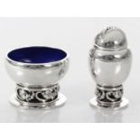 A SILVER BLOSSOM PATTERN SALT AND PEPPER SHAKER BY GEORG JENSEN