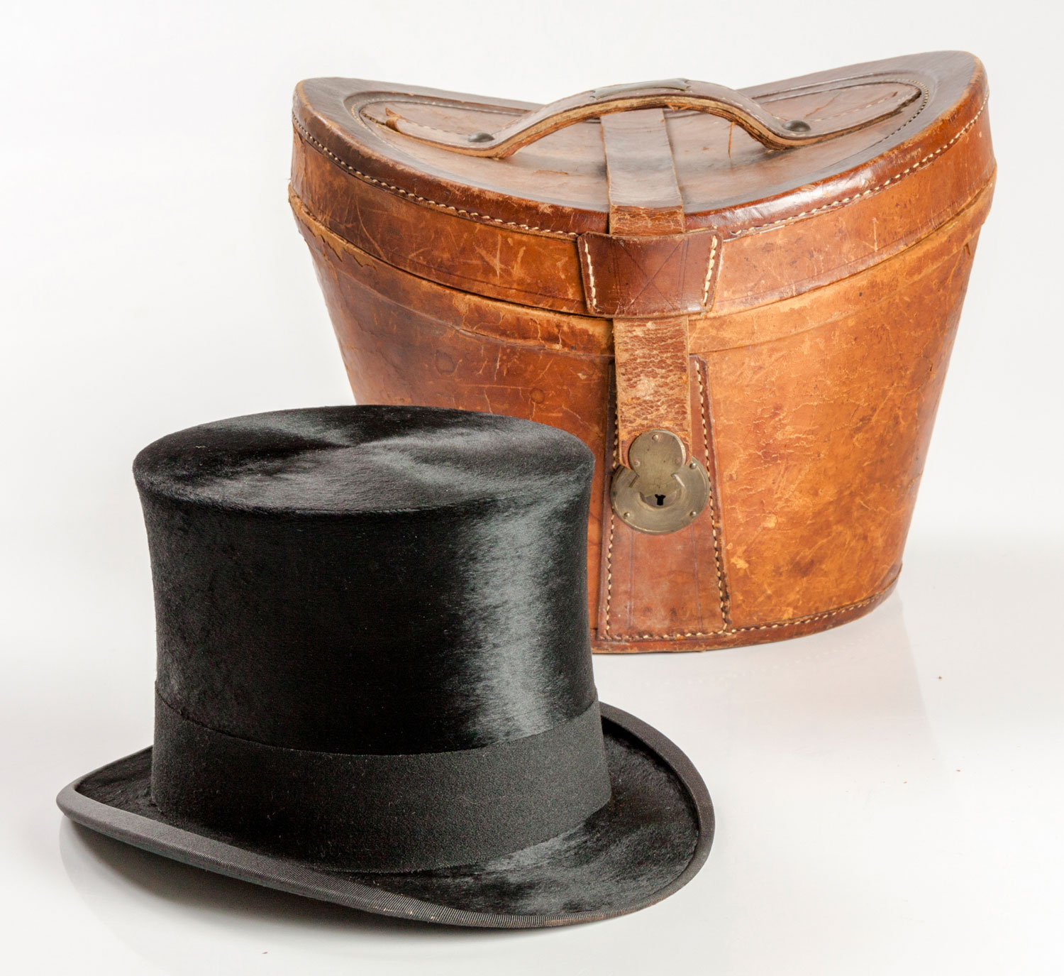 A LEATHER-CASED SILK TOP HAT, HENRY HEATH, 1920