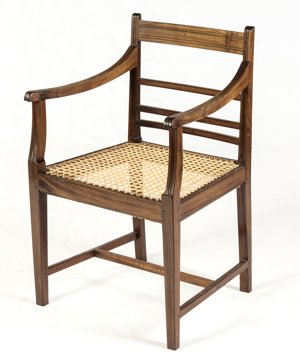 A CAPE STINKWOOD ARMCHAIR, 19TH CENTURY The curved reeded top rail above a reeded mid rail and two