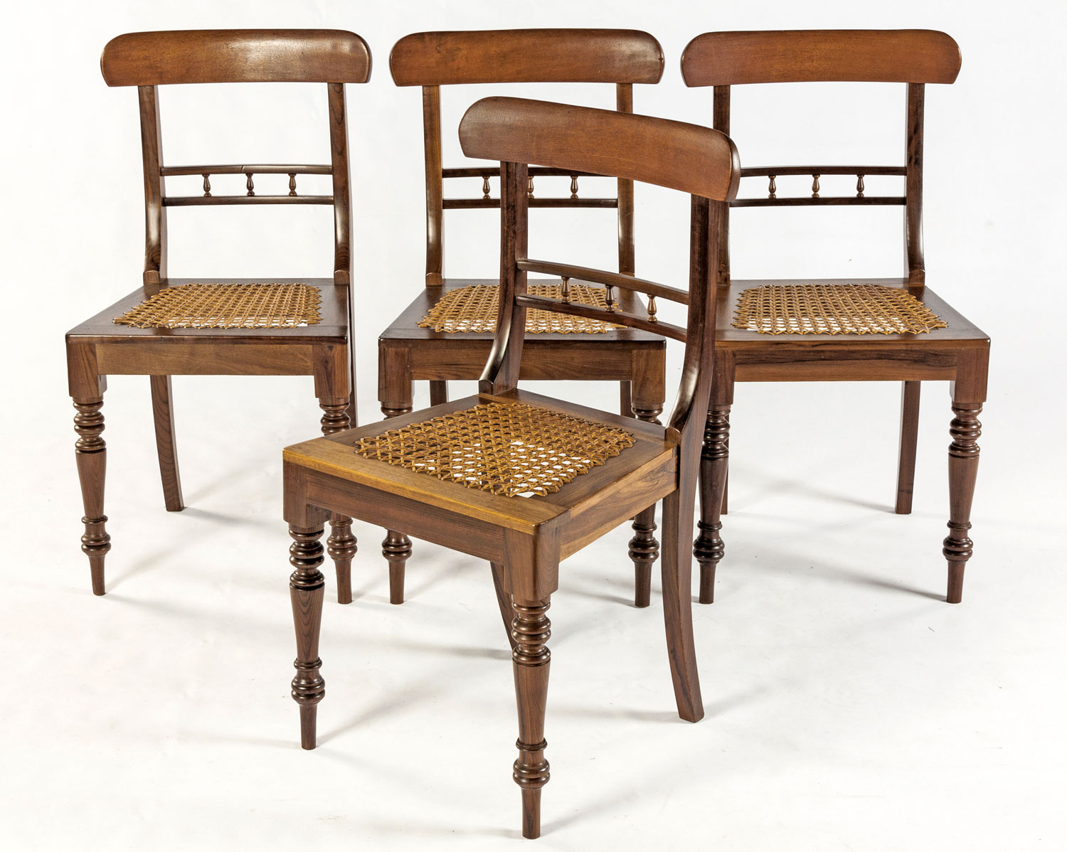 A SET OF FOUR CAPE STINKWOOD REGENCY CHAIRS