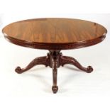 A ROSEWOOD EXTENDING DINING TABLE