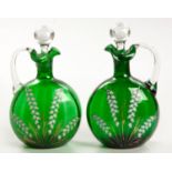 A PAIR OF VICTORIAN GREEN GLASS AND ENAMEL DECANTERS