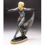 AN ART DECO SILVER PAINTED SPELTER AND CARVED IVORINE FIGURE OF A DANCER