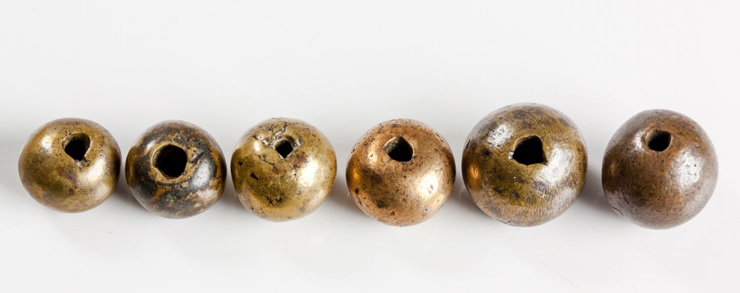 SIX RARE LARGE ZULU BRASS BEADS, 19TH CENTURY