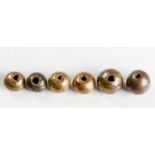 SIX RARE LARGE ZULU BRASS BEADS, 19TH CENTURY