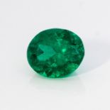 AN UNMOUNTED OVAL MIXED-CUT EMERALD