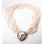 A PEARL NECKLACE Bezel-set to the centre with a blister pearl flanked by 6 round, tapering pearls in