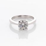 A PLATINUM SOLITAIRE RING Claw-set to the centre with a round brilliant-cut diamond weighing 1,