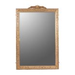 A GILTWOOD MIRROR The rectangular plate within a conforming beaded and moulded frame, surmounted
