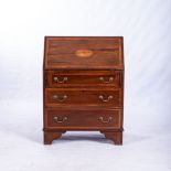 A GEORGE III MAHOGANY BUREAU The rectangular top above a cross-banded and inlaid hinged fall-front