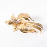 A DIAMOND BROOCH Claw-set to the side with two round brilliant-cut diamonds, the first weighing 0,