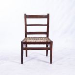 A CAPE STINKWOOD SIDE CHAIR The curved top rail above a reeded mid and bottom rail, caned seat, on
