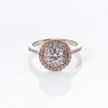 A DIAMOND HALO RING Claw-set to the centre with a round brilliant-cut diamond weighing 0,705cts,