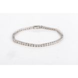 A DIAMOND TENNIS BRACELET Claw-set with 40 round brilliant-cut diamonds weighing 15,01cts in