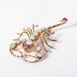 A SCORPION BROOCH Claw set with eleven opals and pave set with three rubies in 15ct rose gold 6cm in