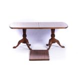 A GEORGE III STYLE MAHOGANY EXTENDING DINING TABLE The rounded rectangular and moulded top on