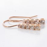 A PAIR OF DIAMOND EARRINGS Each claw set as an articulated row of tapered diamonds with a combined