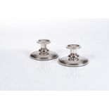 A PAIR OF SILVER CANDLESTICKS, IMPRESSED 830S Each nozzle on a circular base, loaded6cm high(2) (2)