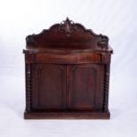 A VICTORIAN MAHOGANY CHIFFONIER The serpentine top surmounted by a moulded and scroll-carved back