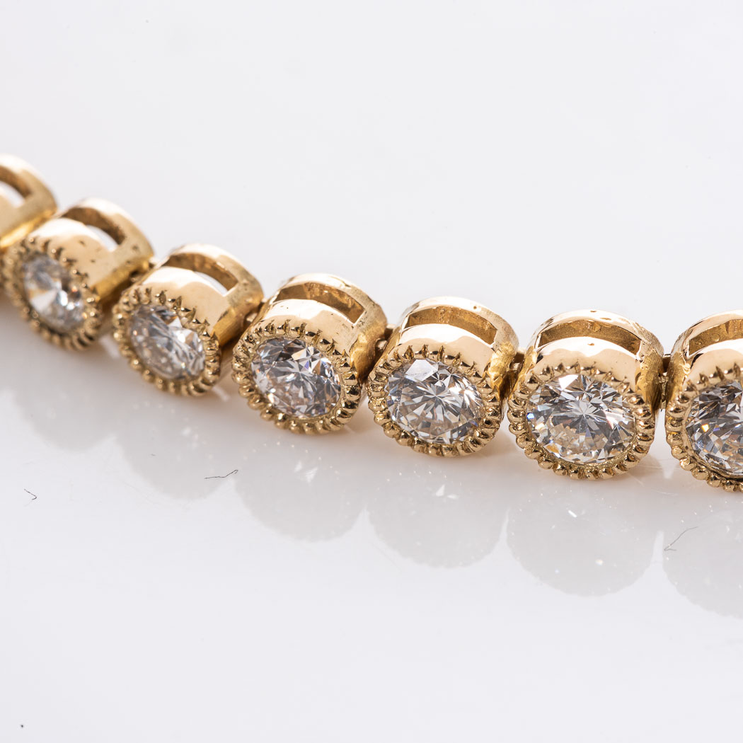 A DIAMOND TENNIS BRACELET Bezel-set with 46 graduated round brilliant cut diamonds weighing 4,70cts, - Image 2 of 2