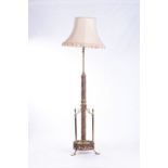 A VICTORIAN CAST IRON AND BRASS STANDARD LAMP The adjustable shaft on an embossed and cast column,