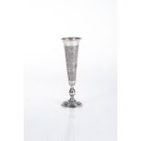 A RUSSIAN SILVER VASE The tapering body chased with flowers, on a circular stepped foot17cm high,