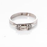 A DIAMOND DRESS RING Open bezel-set to the centre with a baguette-cut diamond weighing 0,27cts,