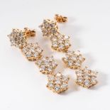 A PAIR OF DIAMOND EARRINGS Each claw-set as a row of five flowerheads affixed by an open link with