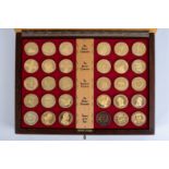 A SET OF GOLD PLATED SILVER COINS Comprising: thirty coins of one ounce each accompanied by original