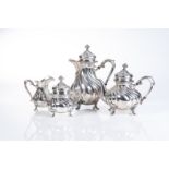 A GERMAN SILVER TEA SET Comprising a teapot, hot water pot, milk jug and sugar bowl, each with a