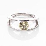 AN 18CT WHITE GOLD DRESS RING Tension-set to the centre with a round brilliant-cut lemon quartz