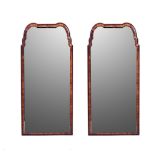 A PAIR OF WALNUT MIRRORS Each shaped bevelled plate within a conforming frame?cm high, ?cm wide (2)