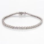 A DIAMOND TENNIS BRACELET Claw-set with 54 graduated round brilliant-cut diamonds weighing 6,
