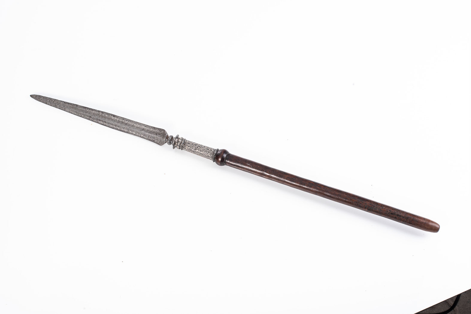 MALAYAN SPEAR c.1800. Cut down wooden shaft. Silver ferrule with heavily-decorated steel head