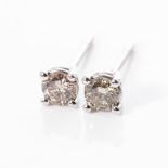 A PAIR OF DIAMOND STUDS Claw-set with two round brilliant-cut diamonds weighing 0,75cts, together in