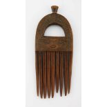 A CHOKWE COMB, ANGOLA The handle pierced and carved with geometric patterns 18cm long