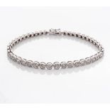 A DIAMOND TENNIS BRACELET Bezel set with 48 graduated round brilliant cut diamonds weighing 4,80