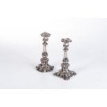 A PAIR OF SHEFFIELD PLATE CANDLESTICKS, EARLY 19TH CENTURY The tapering column surmounted with a