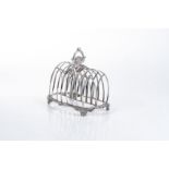 A GEORGE III SILVER TOAST RACK, REBECCA EMES AND EDWARD BARNARD I, LONDON, 1812 Each arched division