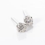 A PAIR OF DIAMOND STUDS Claw-set with two round brilliant-cut diamonds weighing 0,70cts, together in